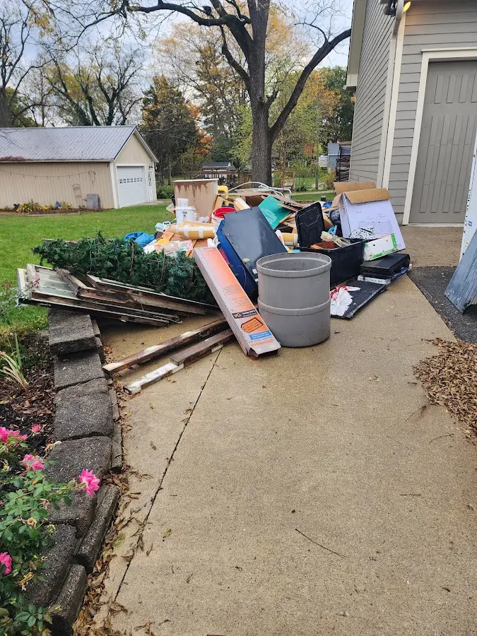 Dumpster being loaded with debris for 12 Yard Dumpster Rental in Wantage